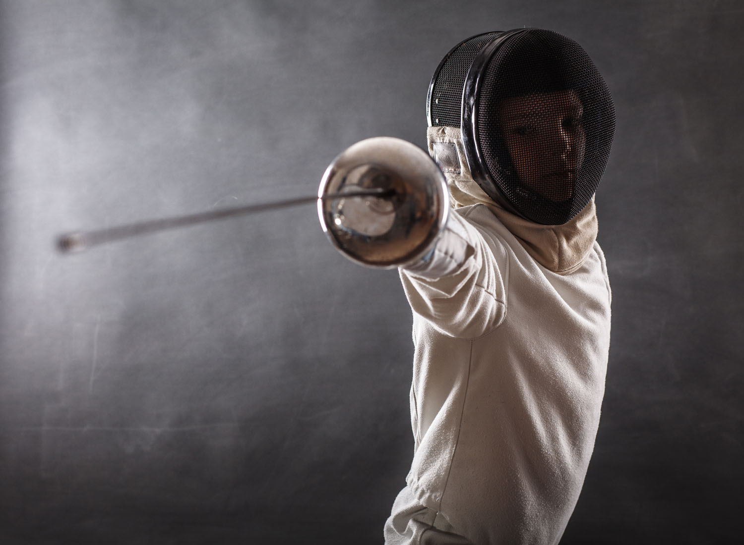 Boy,Wearing,White,Fencing,Costume,And,Black,Fencing,Mask,Standing